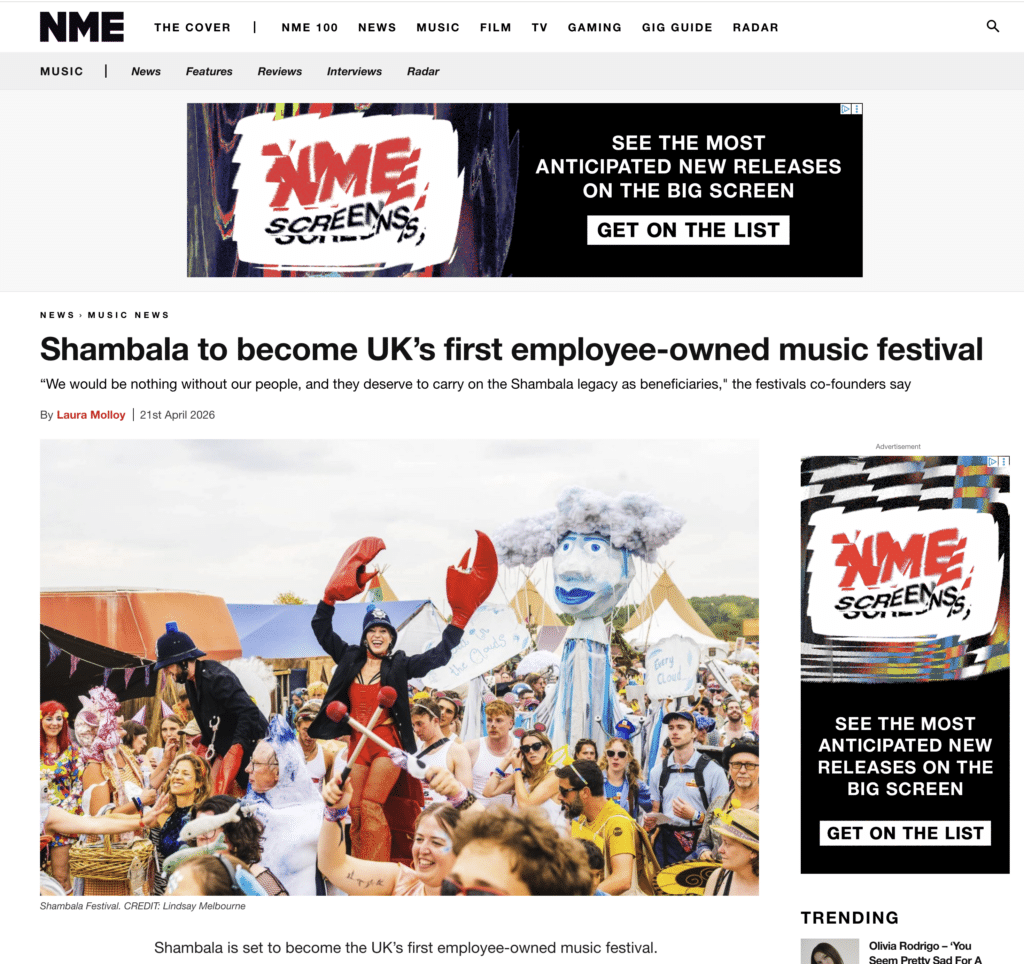 Festival crowd at Shambala with colorful costumes, puppets, and lively atmosphere